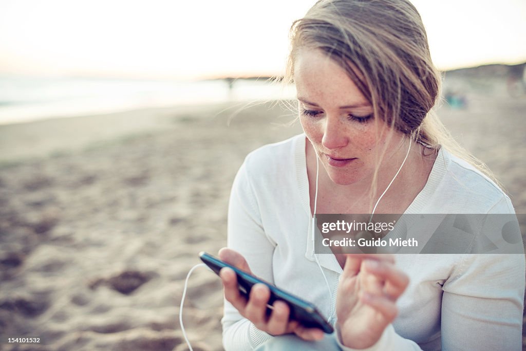 Woman with smart phone at atlantic beach