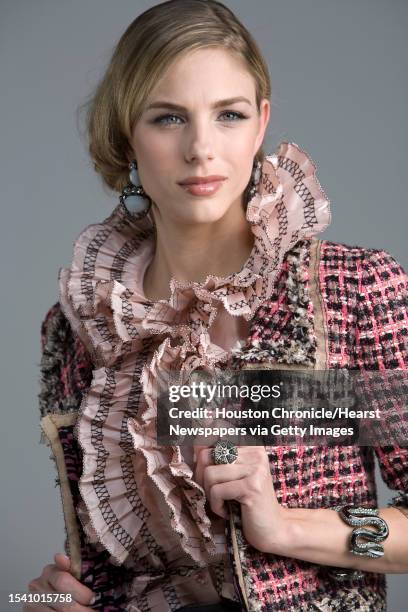 Lindsay Mallia of Page Parkes Models wears Oscar de la Renta's pre-fall 2010 collection pink silk taffeta sleeveless blouse with black threadwork...