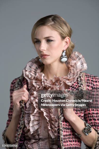 Lindsay Mallia of Page Parkes Models wears Oscar de la Renta's pre-fall 2010 collection pink silk taffeta sleeveless blouse with black threadwork...