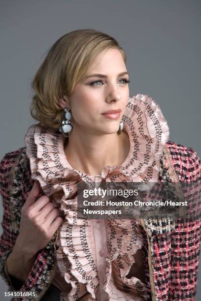 Lindsay Mallia of Page Parkes Models wears Oscar de la Renta's pre-fall 2010 collection pink silk taffeta sleeveless blouse with black threadwork...