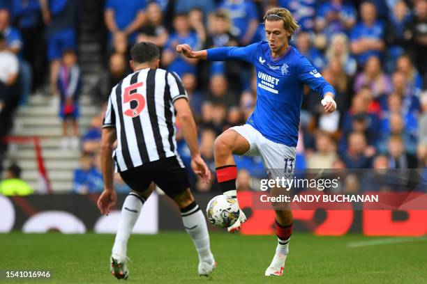 Rangers' English midfielder Todd Cantwell vies with Newcastle United's Swiss defender Fabian Schar during the pre-season friendly football match...