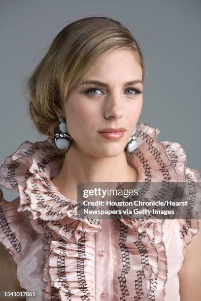 Lindsay Mallia of Page Parkes Models wears Oscar de la Renta's pre-fall 2010 collection pink silk taffeta sleeveless blouse with black threadwork...