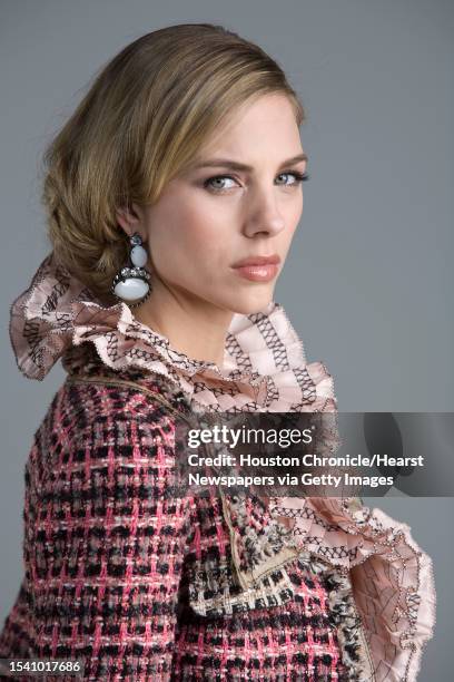 Lindsay Mallia of Page Parkes Models wears Oscar de la Renta's pre-fall 2010 collection pink silk taffeta sleeveless blouse with black threadwork...