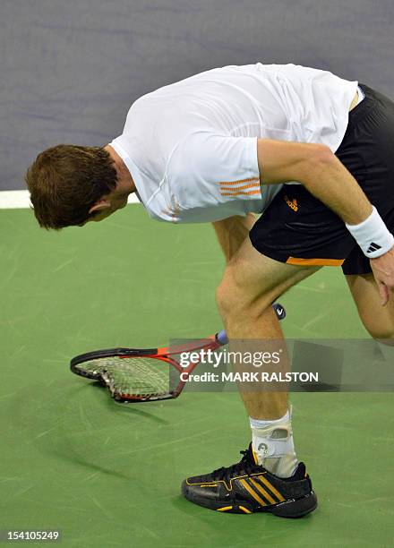 Andy Murray of Britain smashes his racket after missing a point against Novak Djokovic of Serbia during their finals match at the Shanghai Masters...