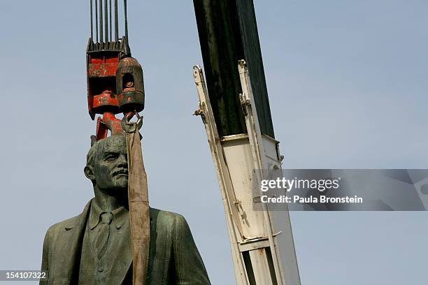 Crane's hoist is attached to the statue of the Vladimir Lenin during a ceremony to remove it after many decades, on October 14, 2012 in Ulan Bator,...