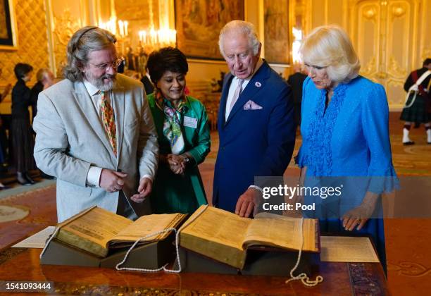 King Charles III and Queen Camilla are shown a first and second folio of works by William Shakespeare by Gregory Doran, Director of the Royal...