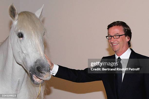 Thaddaeus Ropac poses with a horse as he atttends the opening of his new gallery on October 13, 2012 in Pantin, France.
