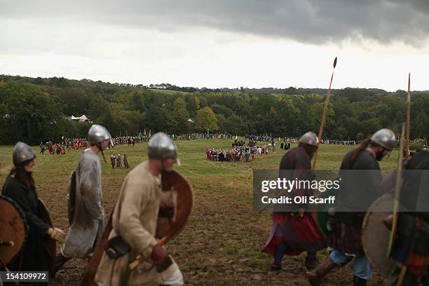 Members of historical re-enactment groups assuming the role of Saxon and Norman soldiers leave the battlefield after the annual re-enactment of the...