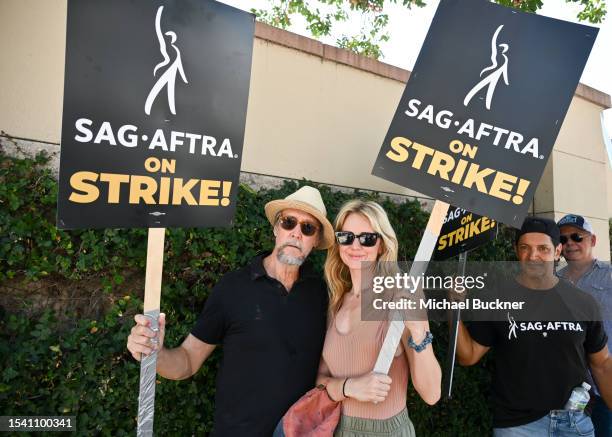 Alan Ruck and Justine Lupe are seen with members of SAG-AFTRA on the picket line on Day 6 in support of the SAG-AFTRA and WGA strike at Warner Bros....