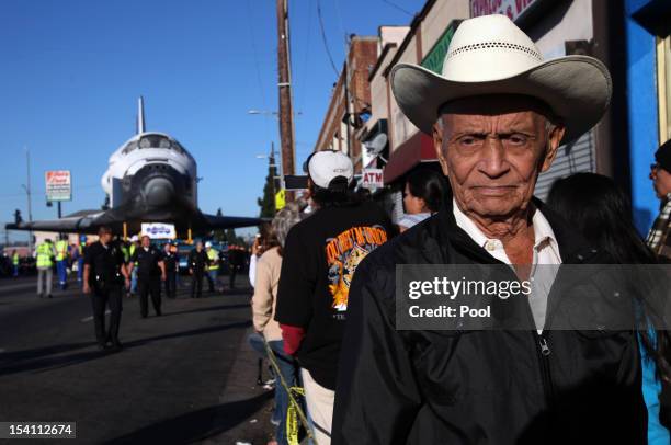 Federico Gonzales is among the many spectators to watch the movement of Space Shuttle Endeavour on Martin Luther King Boulevard to the California...