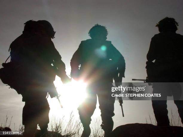 Canadian light infantry soldiers prepare to settle down for the night, 17 March 2002, in the rugged Arma mountains of eastern Afghanistan. Canadian...