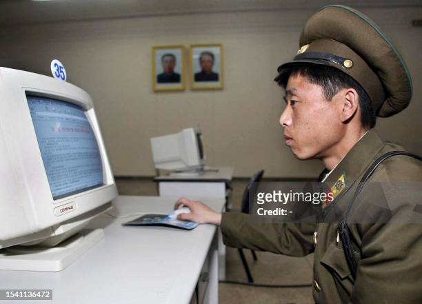 North Korean soldier uses a computer at a library, which has no Internet connections, in Pyongyang, 28 March 2002. Almost 1.2 million USD has been...