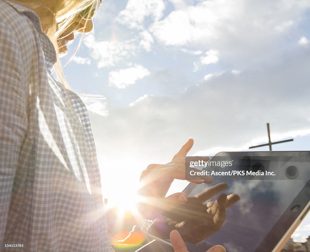 Close-up view of woman using digital tablet