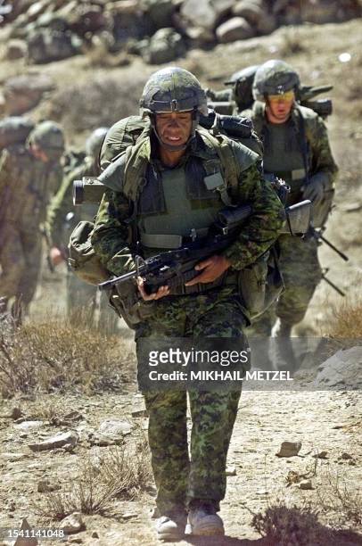 Soldiers from Princess Patricia's Canadian Light Infantry battalion packed tightly with their battle gear and weapons go to a combat mission in the...