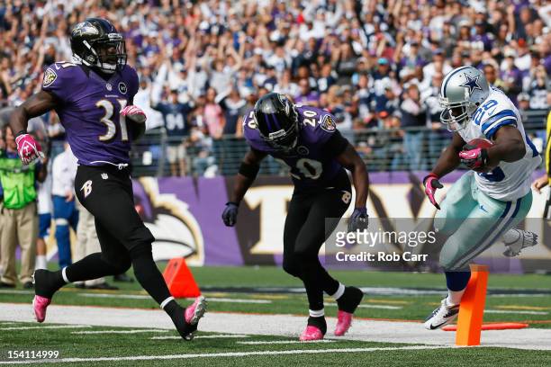 Running back Felix Jones of the Dallas Cowboys scores a touchdown in front of Bernard Pollard and Ed Reed of the Baltimore Ravens during the first...