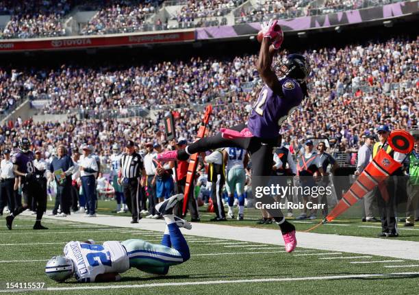 Wide receiver Torrey Smith of the Baltimore Ravens catches a touchdown pass in front of cornerback Morris Claiborne of the Dallas Cowboys during the...