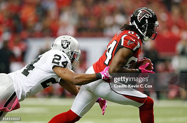 Roddy White of the Atlanta Falcons pulls in this reception against Michael Huff of the Oakland Raiders at Georgia Dome on October 14, 2012 in...