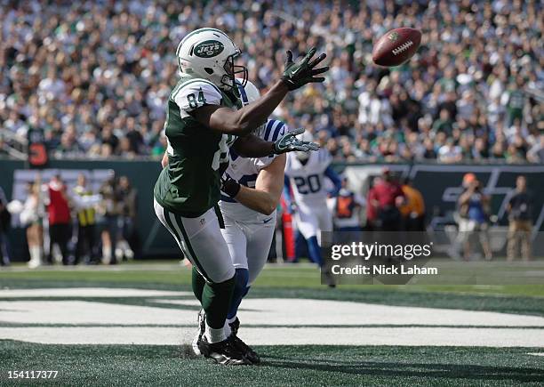 Stephen Hill of the New York Jets catches a touchdown pass under pressure from Tom Zbikowski of the Indianapolis Colts at MetLife Stadium on October...