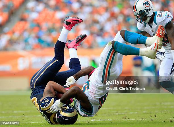 Lance Kendricks of the St. Louis Rams is tackled by Kevin Burnett of the Miami Dolphins at Sun Life Stadium on October 14, 2012 in Miami Gardens,...