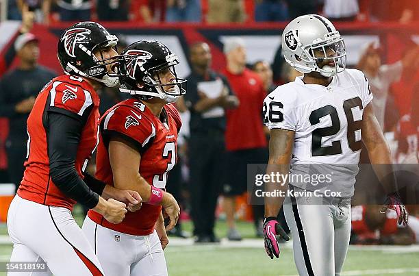 Matt Bryant and Matt Bosher of the Atlanta Falcons watch as Bryant kicks the go-ahead field goal against Pat Lee and the Oakland Raiders at Georgia...