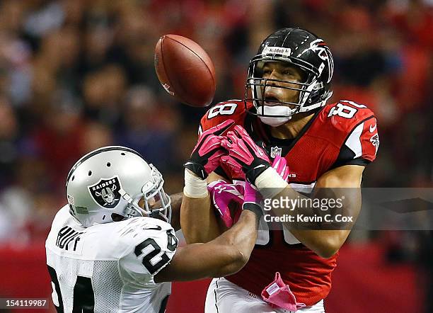 Tony Gonzalez of the Atlanta Falcons fails to pull in this reception against Michael Huff of the Oakland Raiders at Georgia Dome on October 14, 2012...