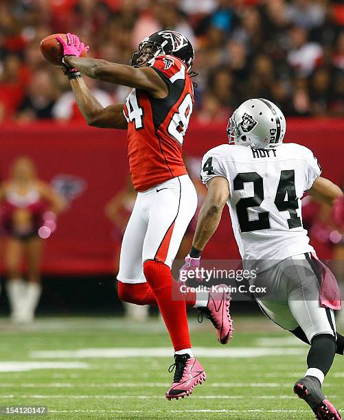 Roddy White of the Atlanta Falcons pulls in this reception against Michael Huff of the Oakland Raiders at Georgia Dome on October 14, 2012 in...