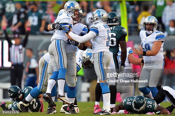 Dylan Gandy and Nick Harris of the Detroit Lions celebrate the game winning field goal with kicker Jason Hanson during the game against the...