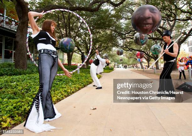 Shay Pruitt, front, of the Luminosity Fire Throwers spinning group twirls a hula hoop as she and her Fire-mates do a demonstration to preview the...