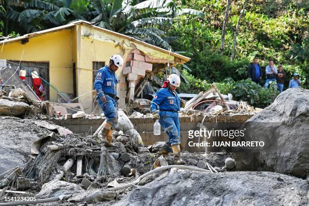 Members of the rescuing team work at the site of a landslide in the Quetame municipality, Cundinamarca department, Colombia, on July 18, 2023. Rescue...