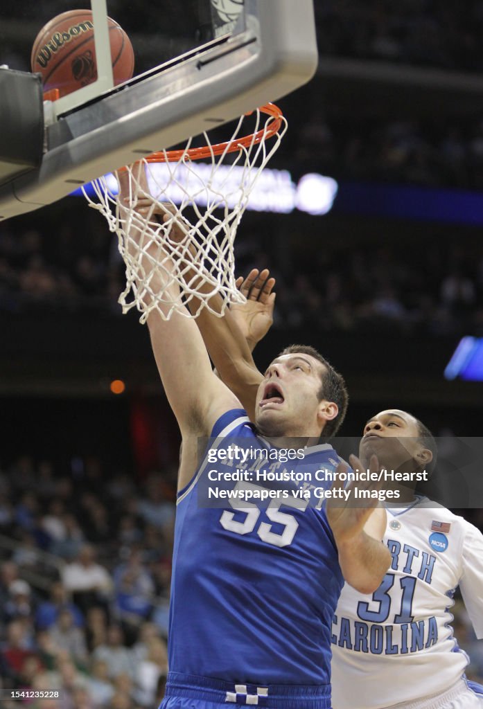 University of Kentucky forward Josh Harrellson is congratulated by a  News Photo - Getty Images