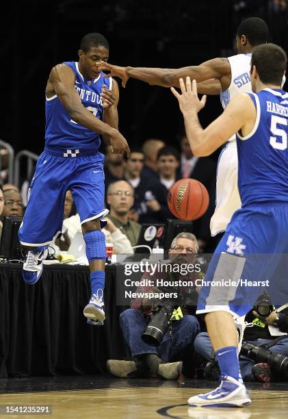 University of Kentucky guard Brandon Knight throws the ball off of University of North Carolina guard Dexter Strickland to keep the possession alive...