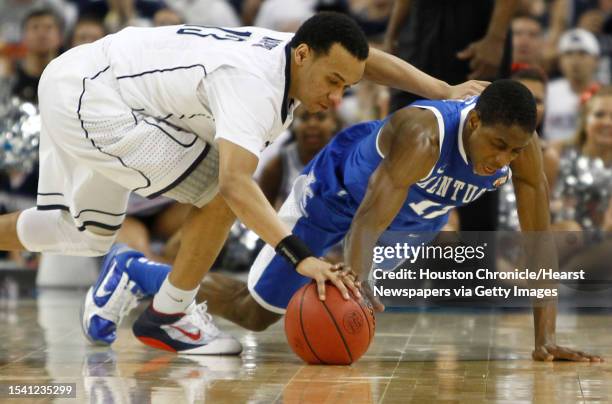 Connecticut guard Shabazz Napier and Kentucky guard Brandon Knight scramble for a loose ball during the second half of the NCAA National Semifinals...