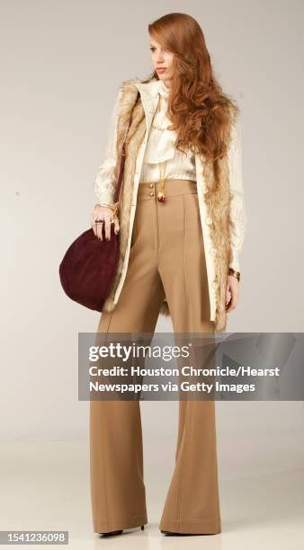 Vicki McCarty of Page.713 wears a Rachel Zoe pants, $375, fur vest, $225, and shirt, $275; with a red pendant necklace, $195, bangles, $250 each,...