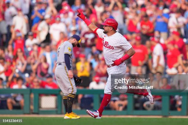Kyle Schwarber of the Philadelphia Phillies celebrates in front of Owen Miller of the Milwaukee Brewers after hitting a solo home run in the bottom...