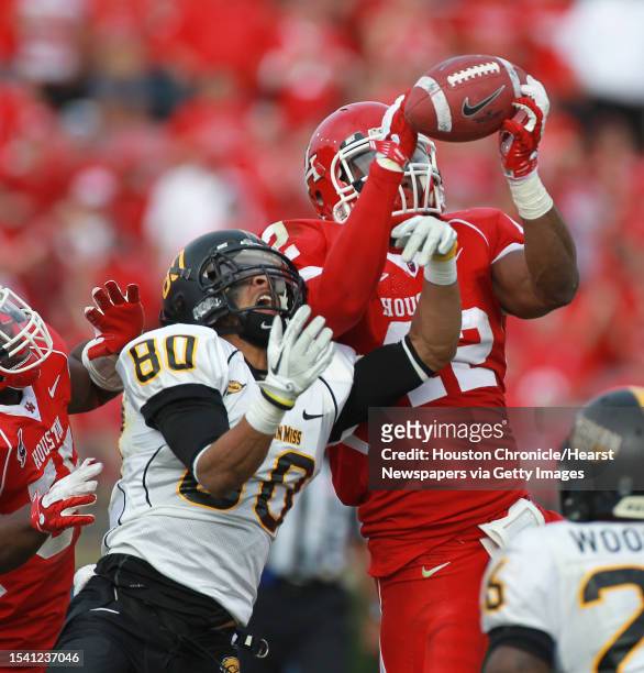 University of Houston linebacker Phillip Steward intercepts the ball as University of Southern Mississippi wide receiver Ryan Balentine tries to...