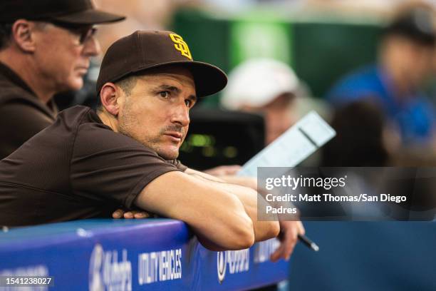 Padres Bench Coach and Offensive Coordinator Ryan Flaherty stands in the dugout during the game against the Toronto Blue Jays at Rogers Centre on...