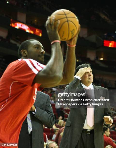 \hHouston Rockets head coach Kevin McHale is greeted by watches his player warm up as he makes his return from a leave to care for his daughter who...