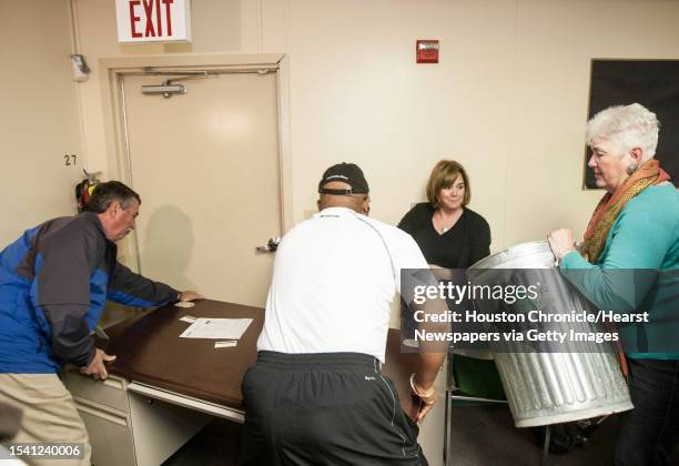 Nancy Morrison, right, of Humble ISD, grabs a trash can to defend herself as she and other participants of the Intruderology training make a...