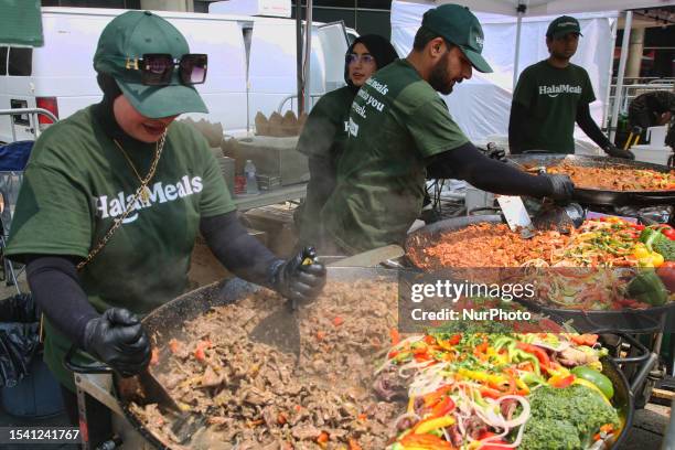 Halal food is prepared featuring beef with rice and tandoori chicken with vegetables during the Taste of the Middle East Food Festival in Toronto,...