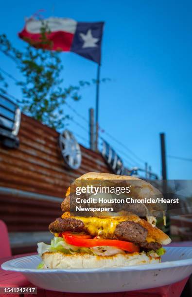 The Hubcap Grill's 19th Street location's Hubcap decker burger. The Hubcap Grill's 19th Street location's Hubcap decker burger. Photographed,...