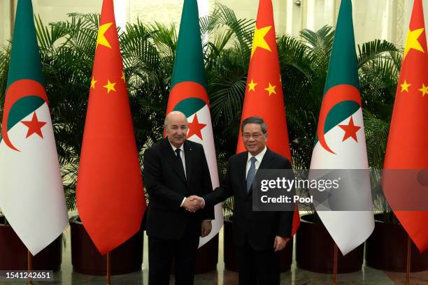 Chinese Premier Li Qiang greets Algerian President Abdelmadjid Tebboune before a meeting at the Great Hall of the People on July 19, 2023 in Beijing,...