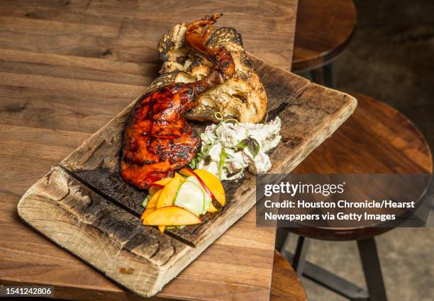 Underbelly's freedom ranger barbecue chicken, potato salad, and pickled peaches. Photographed Wednesday, July 6 in Houston.