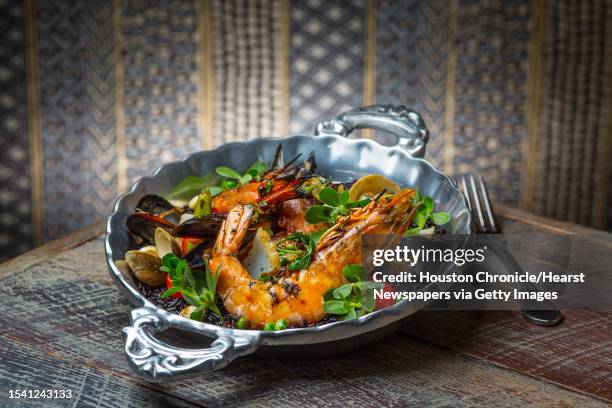 Caracol's mariscos con arroz negro, shrimp, clams, mussels, squid, octopus, chorizo, with rice cooked in black bean broth. Photographed Wednesday,...