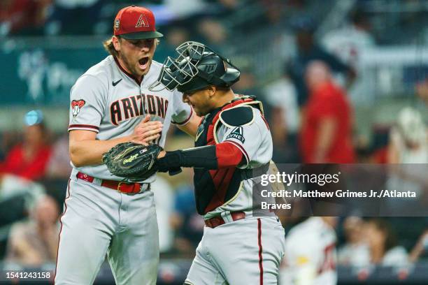 Kevin Ginkel of the Arizona Diamondbacks celebrates with Gabriel Moreno after recording the save during the game against the Atlanta Braves at Truist...