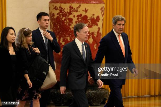 Climate envoy John Kerry walks next to U.S. Ambassador to China Nicholas Burns as they arrive for meetings in the Great Hall of the People on July...