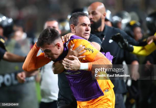 Matheus Donelli of Corinthians receives a punch in the head during the second leg of the round of 32 playoff match between Universitario and...