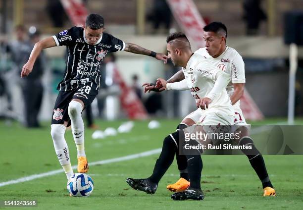 Adson of Corinthians battles for the ball with Luis Urruti and Nelson Cabanillas of Universitario during the second leg of the round of 32 playoff...