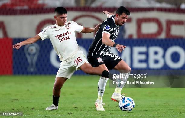 Bruno Mendez of Corinthians battles for the ball with Piero Quispe of Universitario during the second leg of the round of 32 playoff match between...