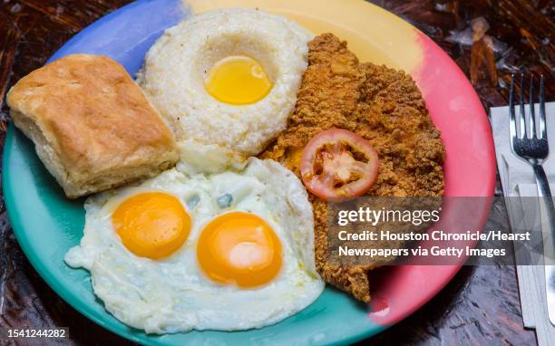 ** Top 100 restaurants **The Breakfast Klub's catfish and grits with sunny side up eggs and biskit. Photographed, Monday, Aug. 15 in Houston.