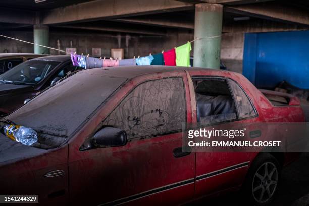 An abandoned vehicle is seen in the parking lot of Ponte City, also known as Ponte Tower, in Berea, Johannesburg on June 8, 2023. The...